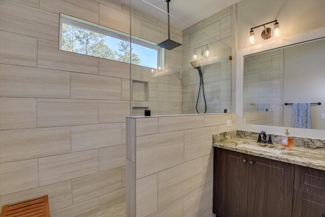 bathroom featuring vanity and a tile shower