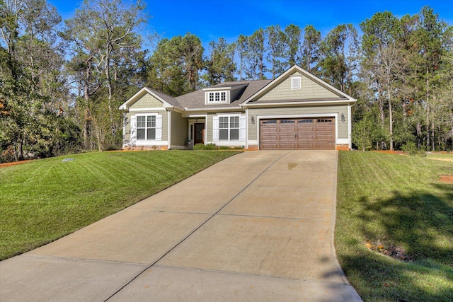 view of front of house featuring a garage and a front lawn