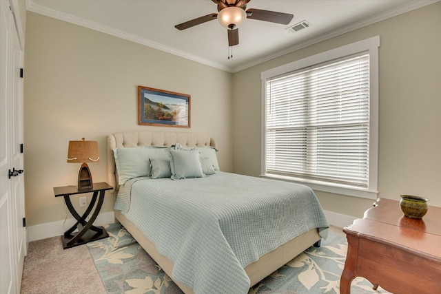 carpeted bedroom with ceiling fan and crown molding