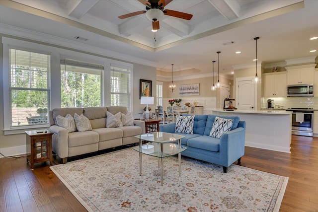 living room with dark hardwood / wood-style flooring, coffered ceiling, ceiling fan, crown molding, and beam ceiling