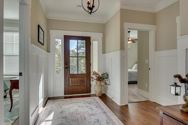 entryway with a wealth of natural light and ornamental molding