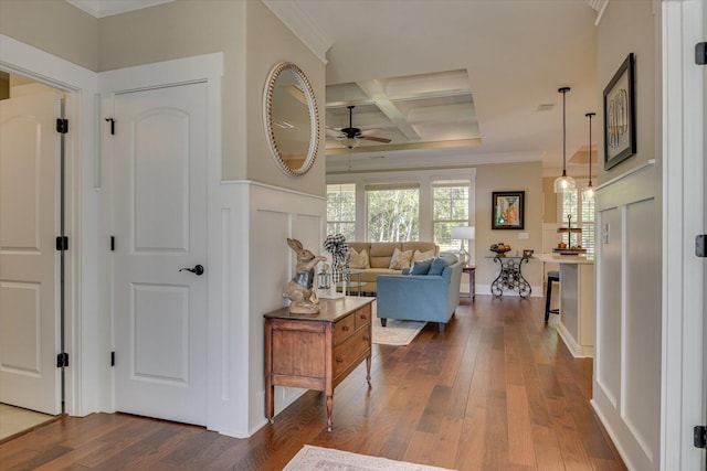 hallway with beamed ceiling, dark hardwood / wood-style flooring, ornamental molding, and coffered ceiling