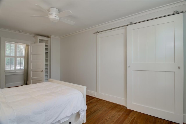 bedroom featuring ceiling fan, dark hardwood / wood-style flooring, and ornamental molding