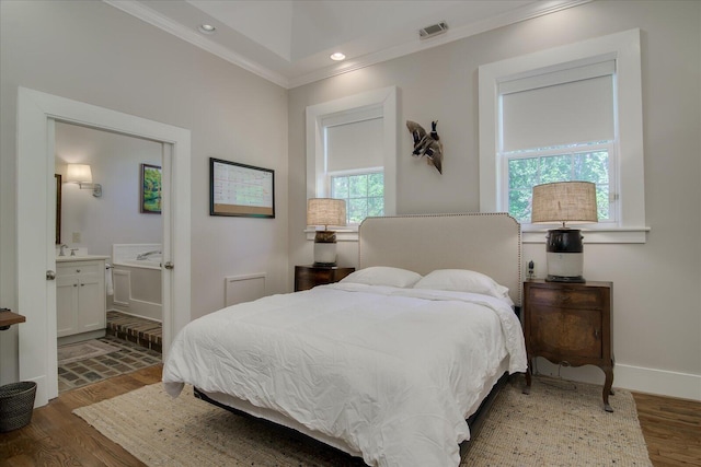 bedroom featuring ensuite bathroom, crown molding, and hardwood / wood-style flooring