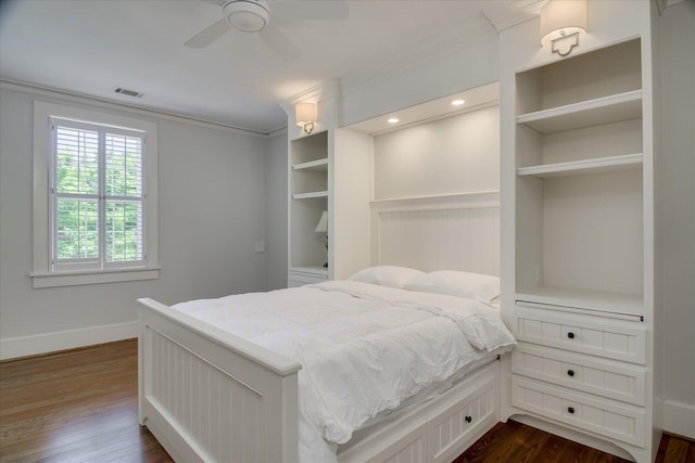 bedroom with ceiling fan, crown molding, and dark wood-type flooring