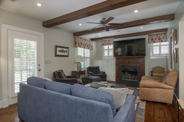 living room with beamed ceiling, dark hardwood / wood-style floors, and ceiling fan