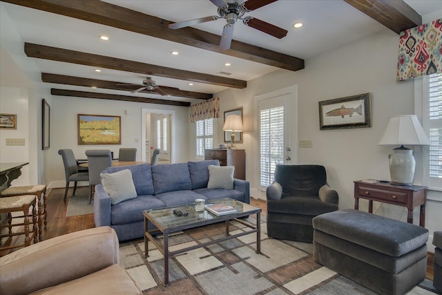 living room featuring beamed ceiling and light wood-type flooring