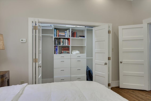 bedroom with dark wood-type flooring