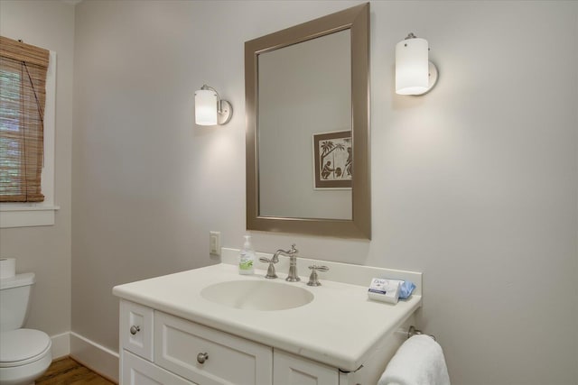 bathroom featuring hardwood / wood-style floors, vanity, and toilet