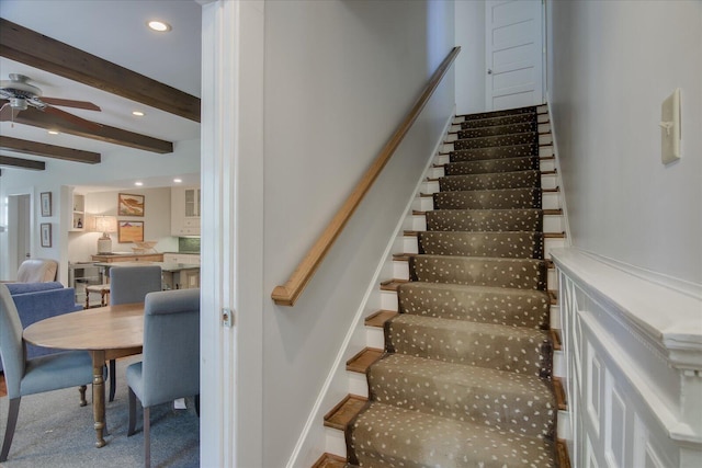 staircase with carpet, beam ceiling, and ceiling fan