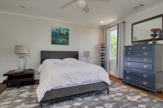 bedroom featuring hardwood / wood-style floors, ceiling fan, and ornamental molding