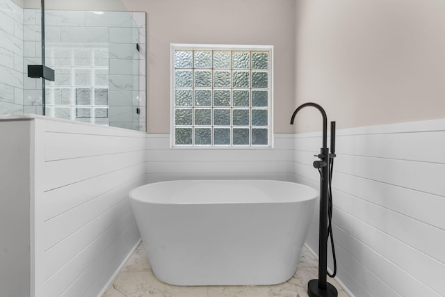 4200 Waters Edge Ln, Appling, GA 30802 - bathroom featuring marble finish flooring, a freestanding tub, wainscoting, a tile shower, and tile walls