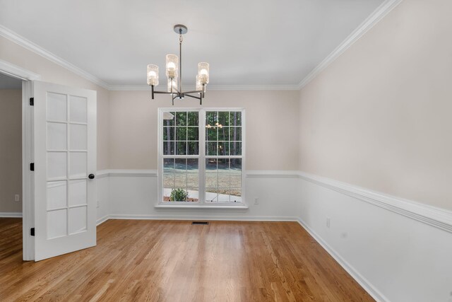 4200 Waters Edge Ln, Appling, GA 30802 - unfurnished dining area featuring wood finished floors, a chandelier, and ornamental molding