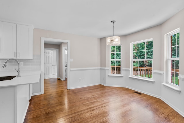 4200 Waters Edge Ln, Appling, GA 30802 - unfurnished dining area with wood finished floors and a chandelier