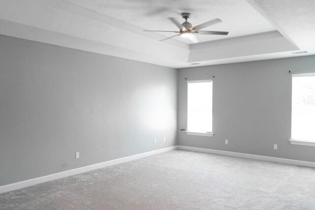 724 Avrett Cir, Evans, GA 30809 - unfurnished room featuring a tray ceiling, baseboards, a ceiling fan, and carpet