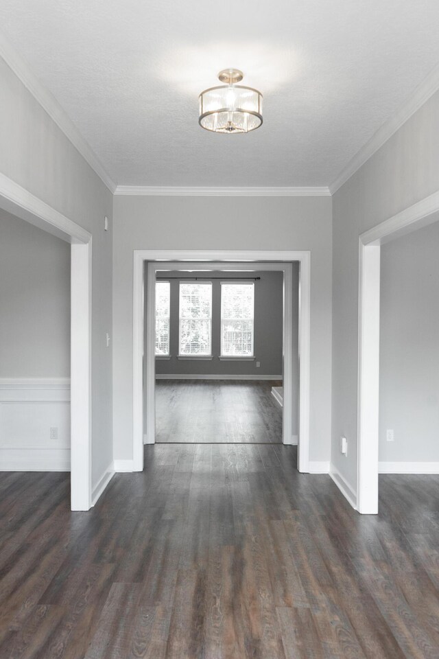 724 Avrett Cir, Evans, GA 30809 - corridor with dark wood-style floors, baseboards, crown molding, and a chandelier