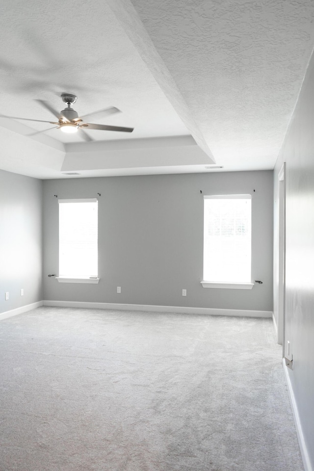 724 Avrett Cir, Evans, GA 30809 - carpeted empty room featuring a textured ceiling, a ceiling fan, a raised ceiling, and baseboards