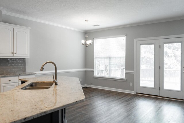 724 Avrett Cir, Evans, GA 30809 - kitchen featuring a sink, white cabinetry, light stone countertops, pendant lighting, and dark wood-type flooring