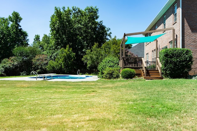 724 Avrett Cir, Evans, GA 30809 - view of grassy yard featuring a wooden deck, an outdoor pool, and view of scattered trees