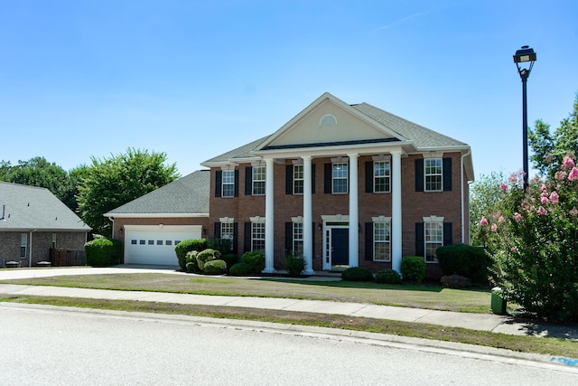 724 Avrett Cir, Evans, GA 30809 - greek revival house with a garage, concrete driveway, and brick siding
