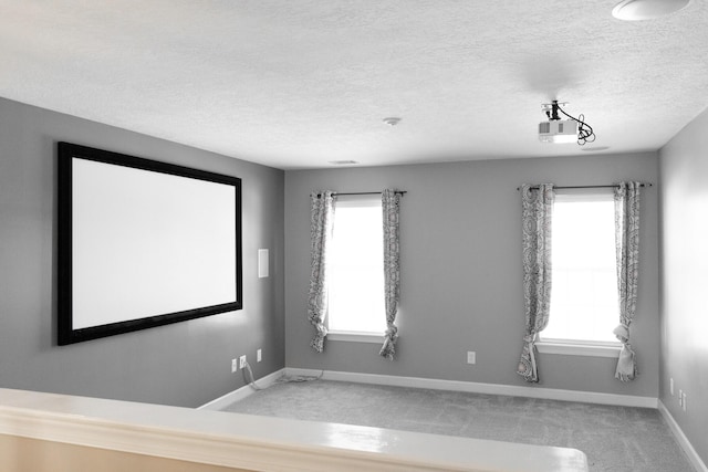 724 Avrett Cir, Evans, GA 30809 - home theater room with carpet flooring, plenty of natural light, baseboards, and a textured ceiling