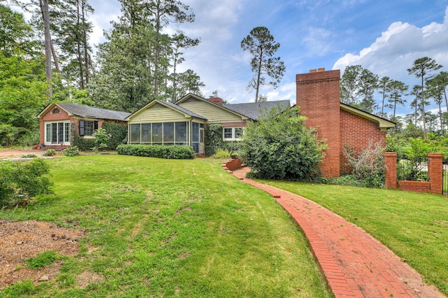 3410 Walton Way, Augusta, GA 30909 - rear view of property with a sunroom, a chimney, a yard, and brick siding