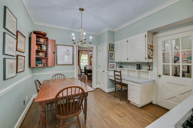3410 Walton Way, Augusta, GA 30909 - dining space featuring light wood-type flooring, a chandelier, crown molding, and built in study area