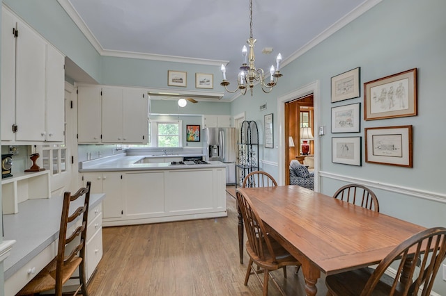 3410 Walton Way, Augusta, GA 30909 - dining room with light wood-type flooring, crown molding, and a chandelier
