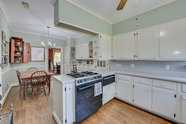 3410 Walton Way, Augusta, GA 30909 - kitchen featuring gas range, a warming drawer, light wood-style flooring, a chandelier, and crown molding