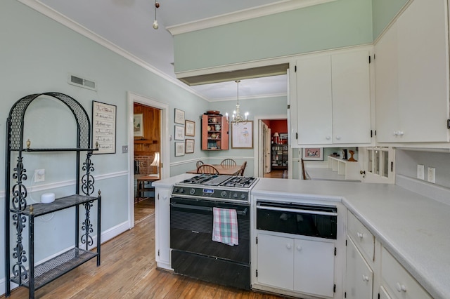 3410 Walton Way, Augusta, GA 30909 - kitchen with black gas range oven, a warming drawer, ornamental molding, a chandelier, and light countertops