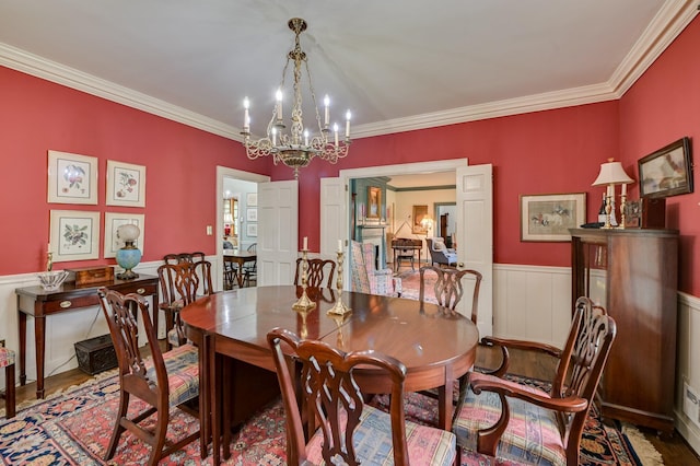 3410 Walton Way, Augusta, GA 30909 - dining room with a chandelier, crown molding, a wainscoted wall, and wood finished floors
