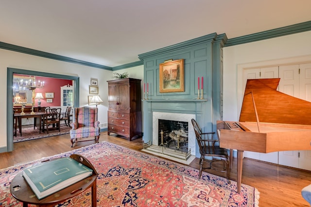 3410 Walton Way, Augusta, GA 30909 - living area featuring crown molding, wood finished floors, a premium fireplace, and a chandelier