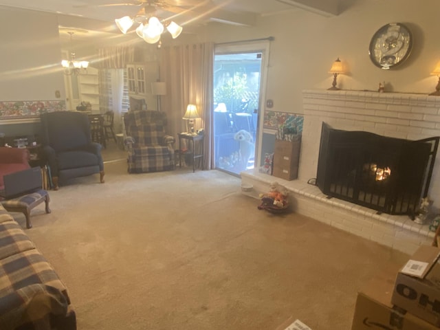 living room featuring beamed ceiling, ceiling fan, carpet floors, and a brick fireplace