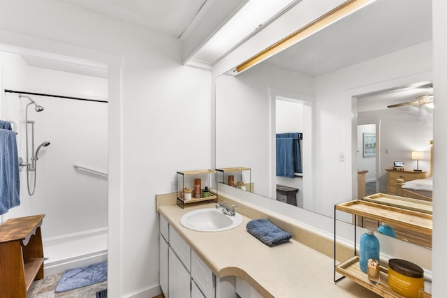 bathroom featuring vanity, ceiling fan, and walk in shower