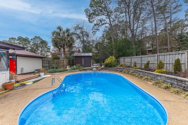 view of swimming pool featuring a shed