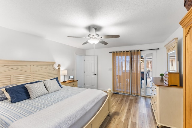 bedroom with ceiling fan, access to exterior, a textured ceiling, and light wood-type flooring