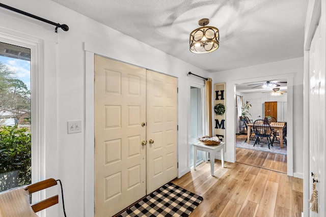 entrance foyer featuring light hardwood / wood-style floors and a textured ceiling