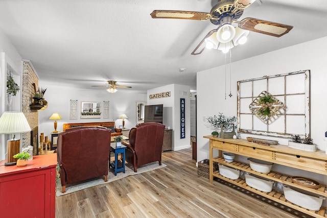 living room featuring ceiling fan and wood-type flooring