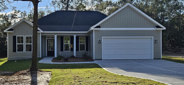 view of front of house with a garage and a front lawn