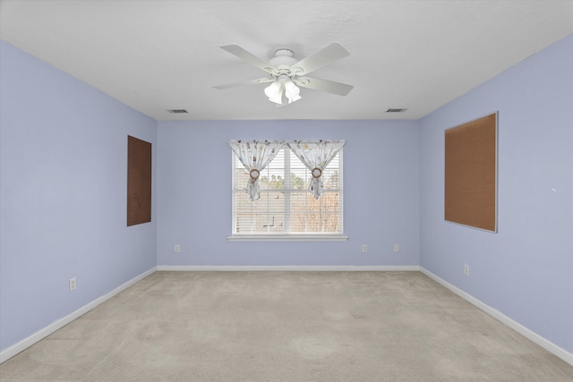 empty room featuring visible vents, baseboards, a ceiling fan, and light colored carpet