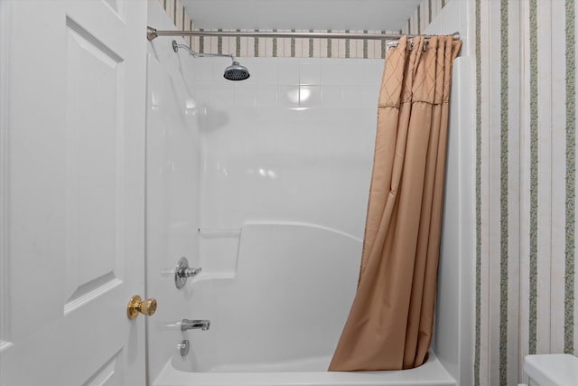 bathroom with shower / bath combo and toilet