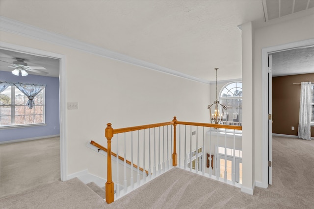 corridor with carpet floors, an upstairs landing, and visible vents