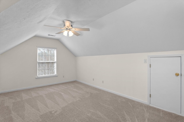 bonus room with carpet, lofted ceiling, visible vents, a textured ceiling, and baseboards