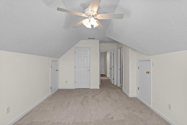 bonus room with visible vents, carpet flooring, vaulted ceiling, a textured ceiling, and baseboards