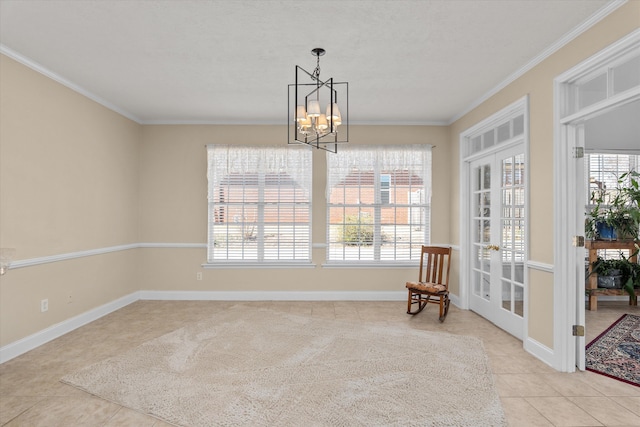 interior space featuring ornamental molding, french doors, baseboards, and an inviting chandelier