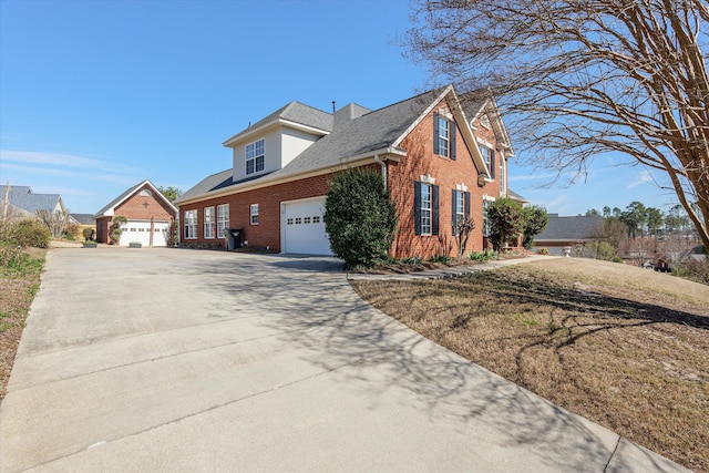 view of front of home with a garage, concrete driveway, brick siding, and a shingled roof