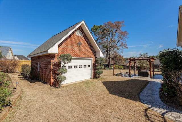 view of property exterior featuring brick siding, an outdoor structure, fence, a yard, and a pergola