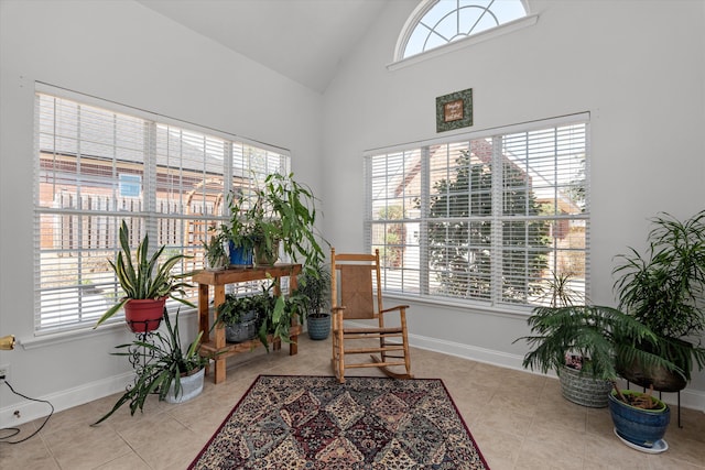 sitting room featuring tile patterned flooring, a wealth of natural light, and baseboards