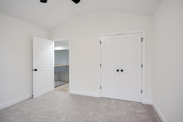 3909 Lakeside Pass, Hephzibah, GA 30815 - unfurnished bedroom featuring carpet flooring, vaulted ceiling, a closet, baseboards, and ceiling fan