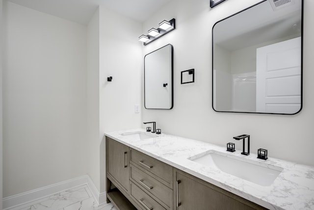 3909 Lakeside Pass, Hephzibah, GA 30815 - bathroom featuring baseboards, double vanity, and marble look tile flooring